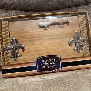 Bamboo serving board with spreader and fleur de lis accents. New.